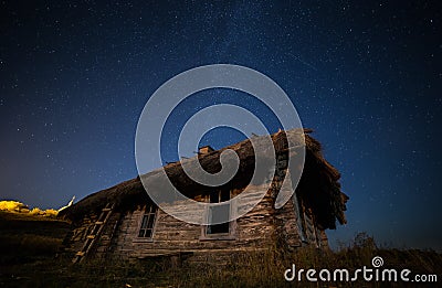 Ukrainian abandoned house in the old village.Against the background of the Milky Way Stock Photo