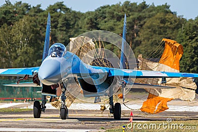 Ukrainian Air Force Sukhoi Su-27 Flanker fighter jet aircraft taxiing with brake parachute after landing on Kleine-Brogel Airbase Editorial Stock Photo