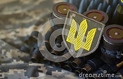 Ukrainian army symbol on machine gun belt lies on ukrainian pixeled military camouflage Stock Photo