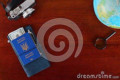 Ukrainian biometric passport. Documents book and globe on the table. Stock Photo