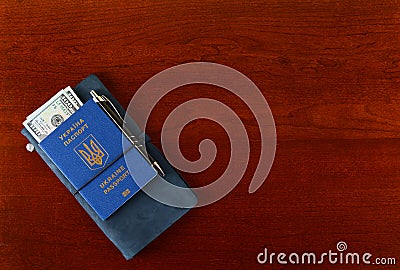 Ukrainian biometric passport. Documents book and money on the table. Stock Photo