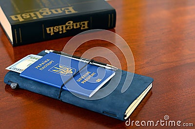 Ukrainian biometric passport. Learning English for business trips abroad. Stock Photo