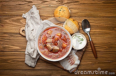 Ukrainian Borscht, red beetroot soup with meat, in white bowl with sour cream, garlic buns Pampushka and salo slices Stock Photo