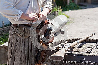 Loading a powder to the barrel of an antique shotgun Stock Photo