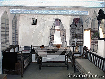Ukrainian historical peasant dwelling interior with various home articles Editorial Stock Photo
