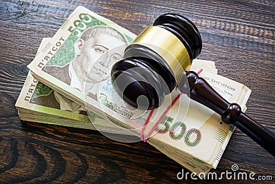 Ukrainian hryvnia money and a gavel. Bribery and corruption in court. Stock Photo