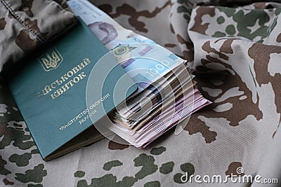 Ukrainian military ID and hryvnia on military uniform Stock Photo