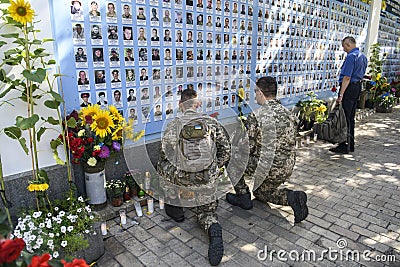 Ukrainian military near Memory Wall of Fallen Defenders of Ukraine in war in Eastern Ukraine 2014-2020. Kyiv, Ukraine Editorial Stock Photo