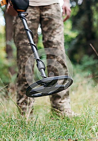 Ukrainian Military sapper with a metal detector in the field. Explosive Ordnance Disposal Officer Stock Photo