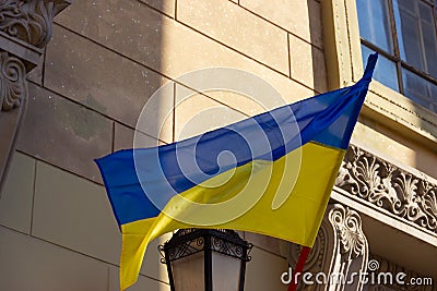 The Ukrainian national flag flutters over the entrance to the polling station. presidential elections in Ukraine in 2019 Editorial Stock Photo