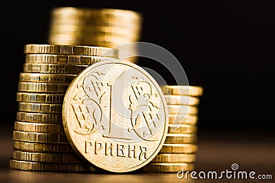 Ukrainian one hryvnia coin and gold money on the desk Stock Photo