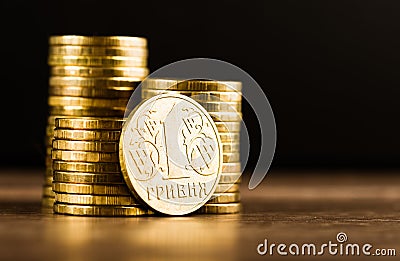 Ukrainian one hryvnia coin and gold money on the desk Stock Photo