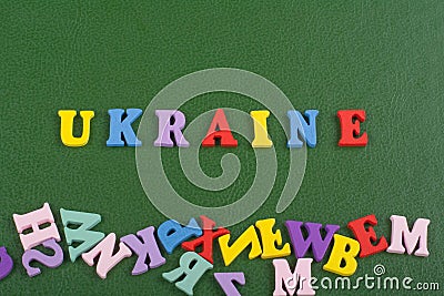 UKRAINIAN word on green background composed from colorful abc alphabet block wooden letters, copy space for ad text Stock Photo