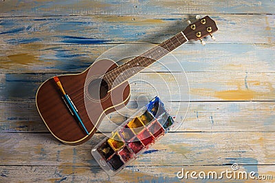 Ukulele with brush and color palette Stock Photo