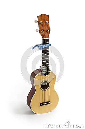 Ukulele and Capo isolated on white Clipping path included : does not include shadow. Stock Photo