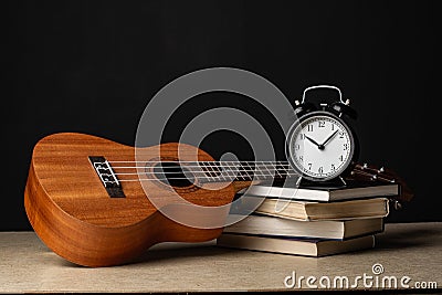 Ukulele, watch and books Stock Photo