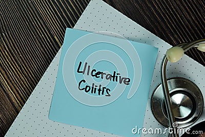 Ulcerative Colitis write on sticky notes isolated on Wooden Table. Medical or Healthcare concept Stock Photo