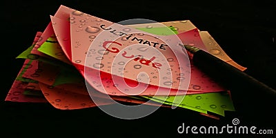 ultimate guide text written on water drop abstract background with pen pointer Stock Photo