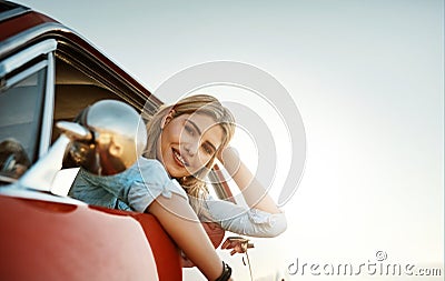 The ultimate summer activity, a road trip. Portrait of a beautiful young woman going on a summers road trip. Stock Photo