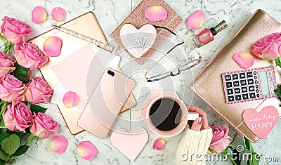 Ultra feminine pink desk workspace with rose gold accessories flatlay. Stock Photo