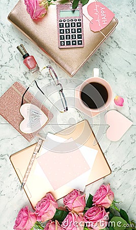 Ultra feminine pink desk workspace with rose gold accessories flatlay. Stock Photo
