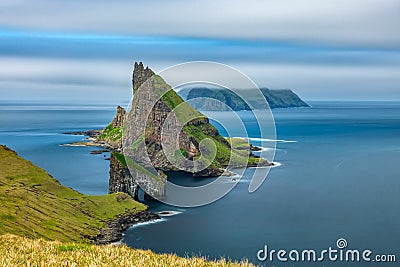 Amazing top view long exposure of Drangarnir gate in front of Tindholmur, Faroe Islands Stock Photo