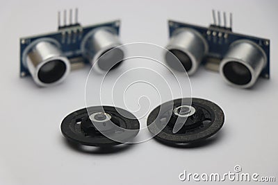 Ultrasonic sensor use to make various range measuring projects on white background with wheels that shows robotic projects concept Stock Photo