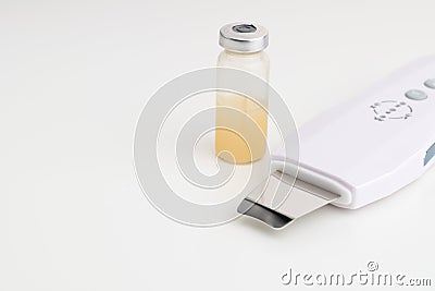 Ultrasonic skin spatula with serum in glass. Salon skin care Stock Photo