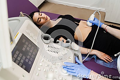 Ultrasound of abdominal organs of girl for diagnosis of liver, pancreas, gallbladder. Abdominal ultrasound for Stock Photo