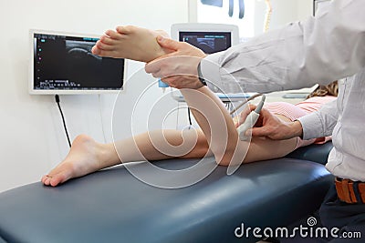 Ultrasound of girl`s knee-joint - diagnosis Stock Photo