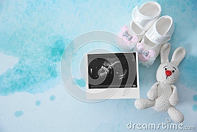 Ultrasound photo, baby shoes and toy on color background, top view Stock Photo