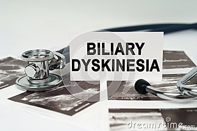 On the ultrasound pictures there is a stethoscope and a business card with the inscription - Biliary dyskinesia Stock Photo