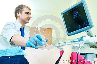 Ultrasound test. Pregnancy. Gynecologist checking fetal life with scanner. Stock Photo
