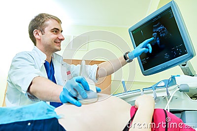 Ultrasound test. Pregnancy. Gynecologist checking fetal life with scanner. Stock Photo