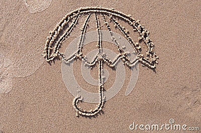 Umbrella drawn in the sand. Beach background. Stock Photo