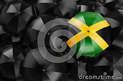 Umbrella with Jamaican flag among black umbrellas, 3D rendering Stock Photo