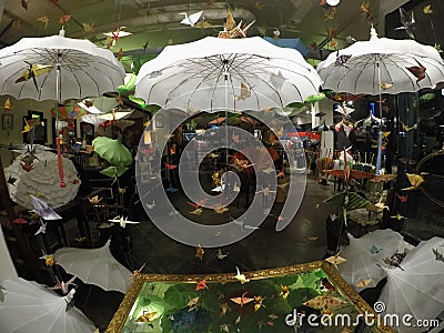 Umbrella paradise with flying origami birds. Stock Photo