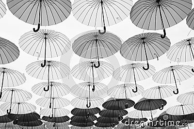 Umbrella sky project installation. Umbrellas float in sky on sunny day. Outdoor art design and decor. Holiday and Editorial Stock Photo