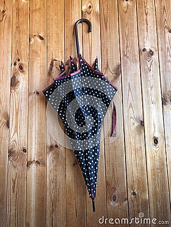 Umbrella on a wooden wall Stock Photo