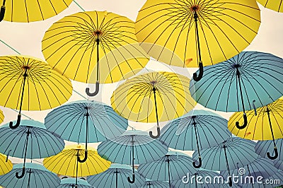 Umbrellas float in sky on sunny day. Umbrella sky project installation. Outdoor art design and decor. Holiday and Editorial Stock Photo