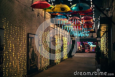 the umbrellas are hanging down over a street at night Editorial Stock Photo