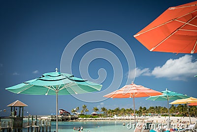 Umbrellas and people relaxing at the beach Editorial Stock Photo