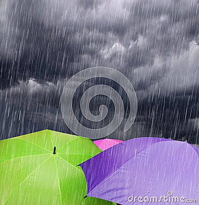 Umbrellas in Rainy Storm Clouds Stock Photo