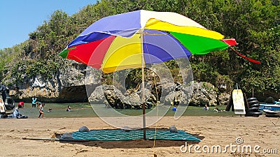 Umbrellas that are rented for shelter on Baron Beach, Gunungkidul, Yogyakarta in the morning Editorial Stock Photo