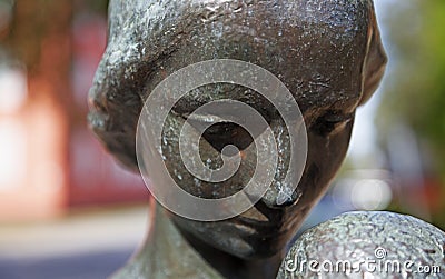 Face on statue, woman with child at Umedalen Editorial Stock Photo