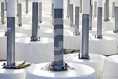 Many cement bases for flagpoles standing close to each other Editorial Stock Photo