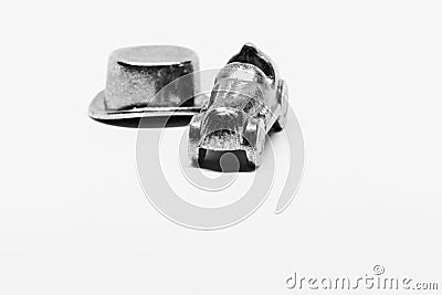 Game pieces from Monopoly, car and hat on white background with studio lights Editorial Stock Photo