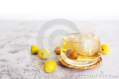 `Umeshu` on rock, a glass of Japanese plum wine `Umeshu` with iced Stock Photo