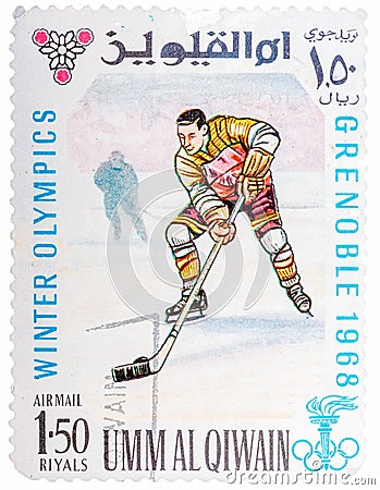 Stamp printed by Umm al-Quwain, shows hockey player bats the puck Editorial Stock Photo