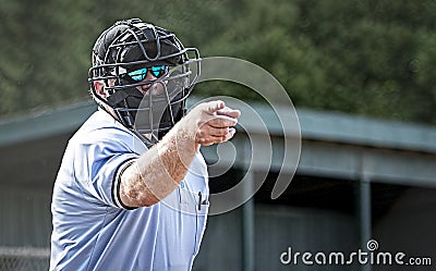 Umpire in blue uniform calls a strike Stock Photo